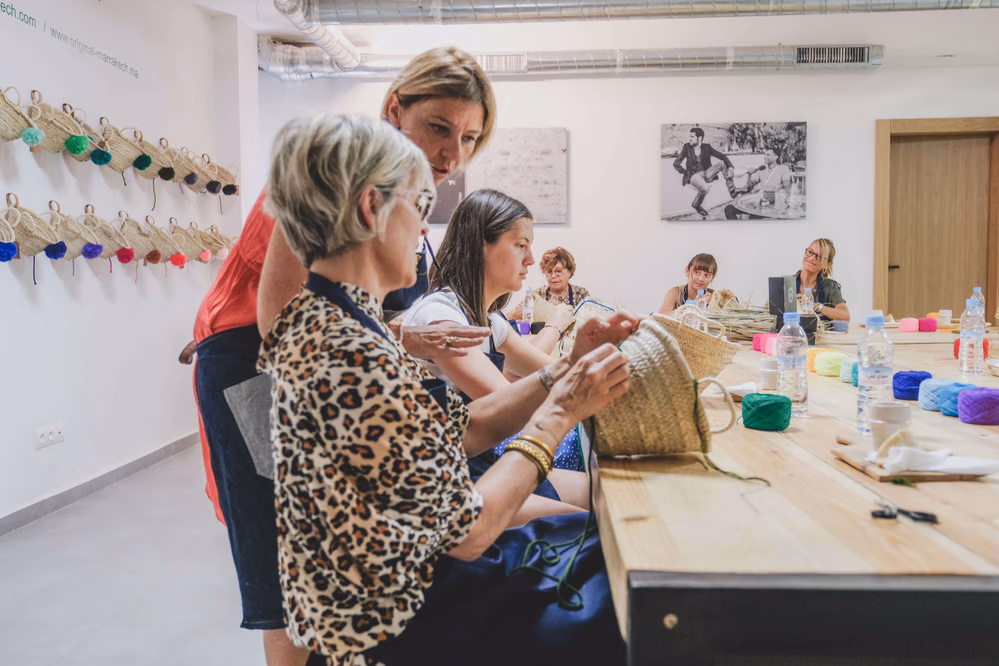 Participants focused during an embroidery workshop at Original Marrakech, guided by an instructor.